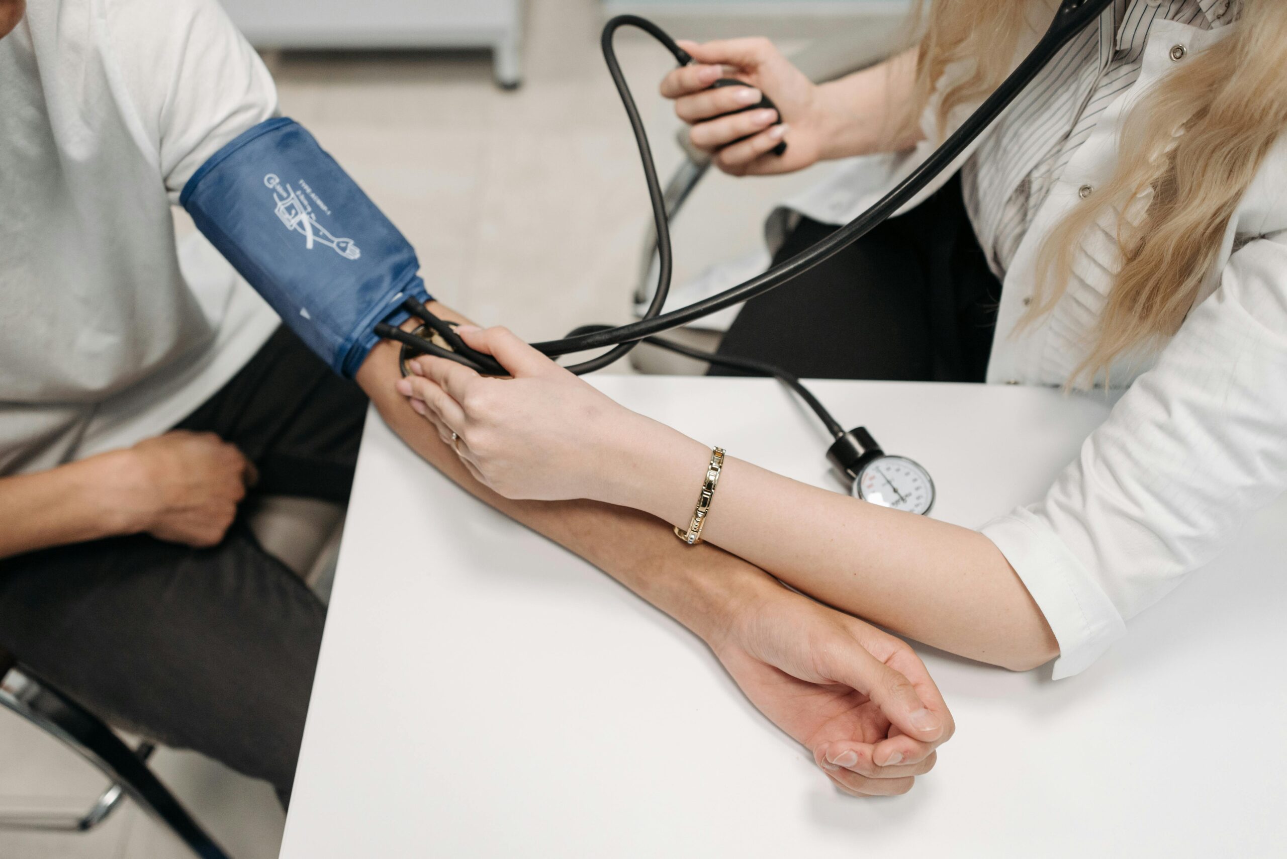 A doctor is measuring blood pressure A doctor is measuring blood pressure
